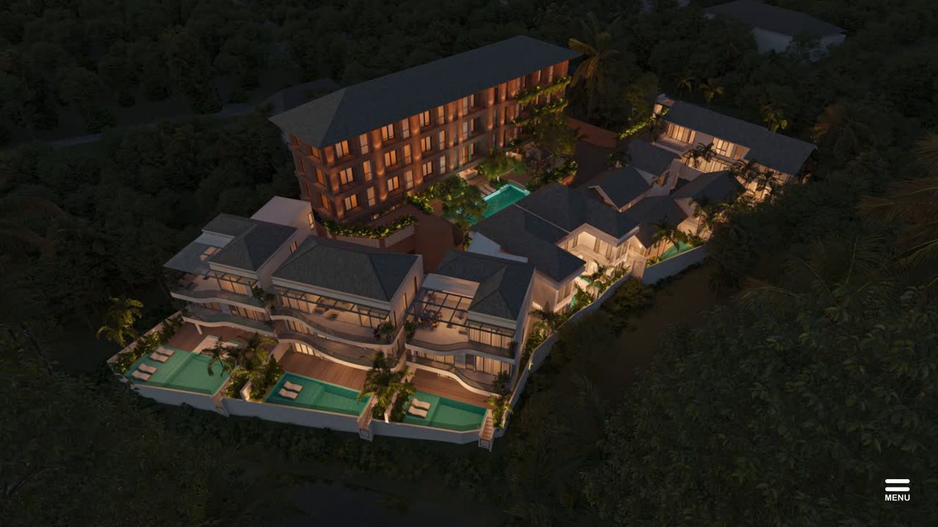 Aerial view of the Sanur coastline at dusk with residential rooftops and the sea beyond